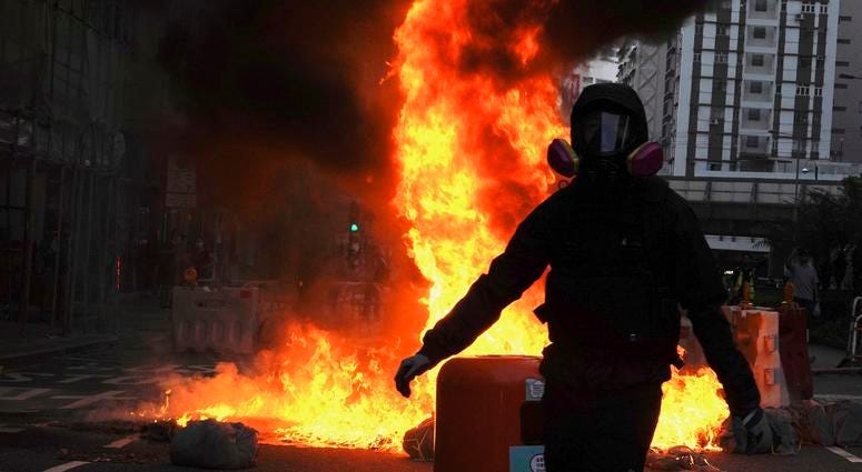 Hong Kong protesters again flooded streets on Sunday, ignoring a police ban on the rally and setting up barricades amid tear gas and firebombs. Protestors set fire on a street to prevent police from approaching in Hong Kong, Sunday, Oct. 20, 2019.