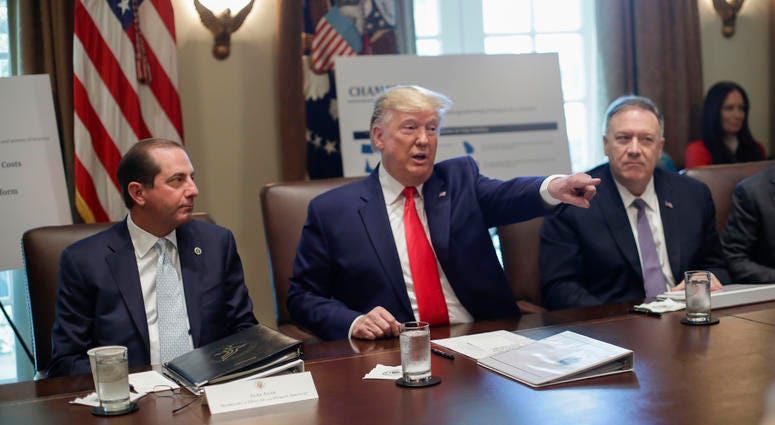 President Donald Trump points to members of his Cabinet while speaking during a Cabinet meeting, Oct. 21, 2019, in Washington, as Health and Human Services Secretary Alex Azar, left, and Secretary of State Mike Pompeo, right, listen. President Donald Trump with members of his Cabinet