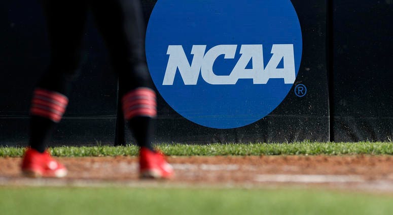 In this April 19, 2019, file photo, an athlete stands near a NCAA logo during a softball game in Beaumont, Texas. NCAA