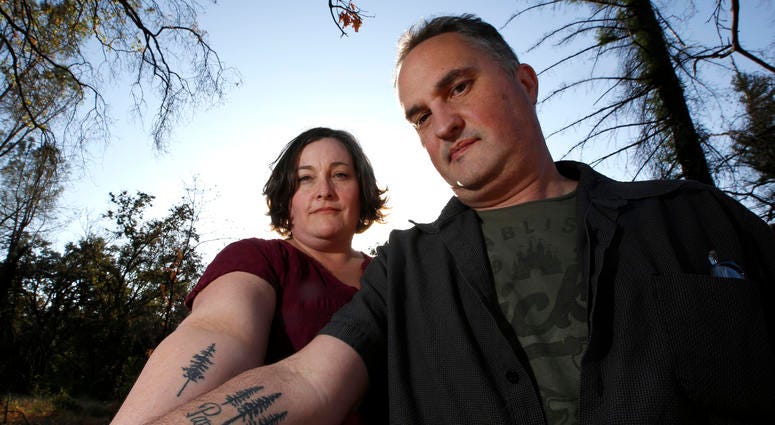 Laura and Chris Smith display their Paradise tattoos they had done to show support for their former community during a visit to Paradise, Calif. Laura and Chris Smith display their Paradise tattoos they had done to show support for their former community during a visit to Paradise, Calif.