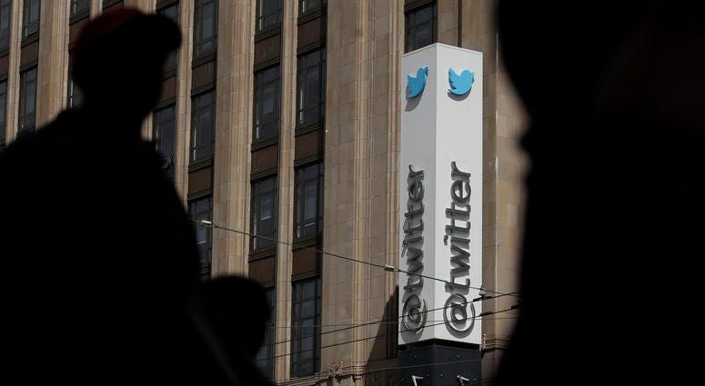 Pedestrians walk across the street from the Twitter office building in San Francisco. Pedestrians walk across the street from the Twitter office building in San Francisco.
