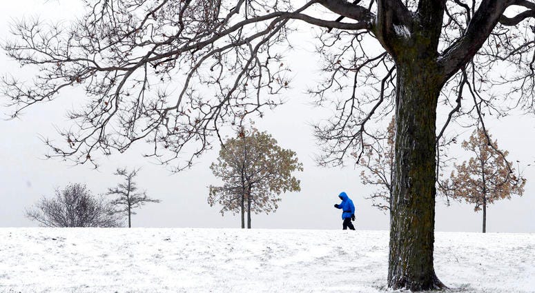 A lone hiker navigates the 31st street beach bike trail in a stiff wind and blowing snow off Lake Michigan, Monday, Nov. 11, 2019, in Chicago. A lone hiker navigates the 31st street beach bike trail in a stiff wind and blowing snow off Lake Michigan.