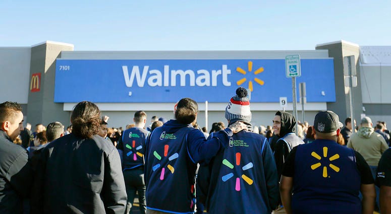 Walmart employees gather outside the Walmart store for a reopening event, Thursday, Nov. 14, 2019 in El Paso, Texas. El Paso Walmart employees