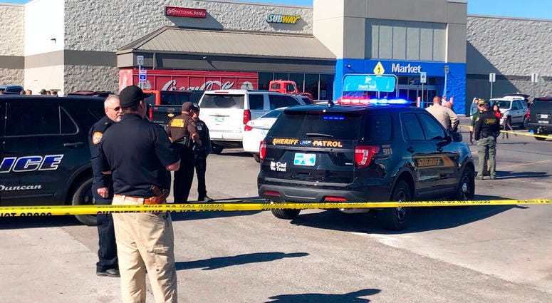 Law enforcement work the scene where two men and a woman were fatally shot Monday, Nov. 18, 2019, outside a Walmart store in Duncan, Okla. Law enforcement work the scene where two men and a woman were fatally shot Monday, Nov. 18, 2019, outside a Walmart store in Duncan, Okla.
