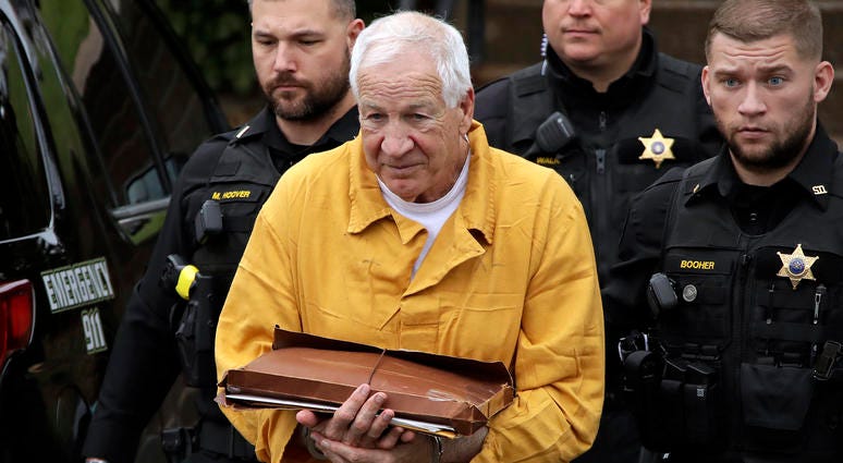 Former Penn State University assistant football coach Jerry Sandusky, left, arrives at the Centre County Courthouse for resentencing on his conviction of 45 counts of child sexual abuse Friday, Nov. 22, 2019, in Bellefonte, Pa. Jerry Sandusky