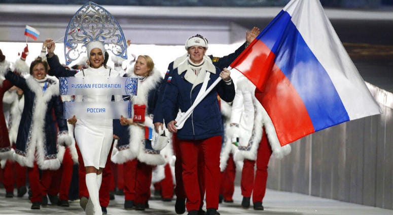 FILE - In this Feb. 7, 2014 file photo Alexander Zubkov of Russia carries the national flag as he leads the team during the opening ceremony of the 2014 Winter Olympics in Sochi, Russia. Alexander Zubkov of Russia carries the national flag.