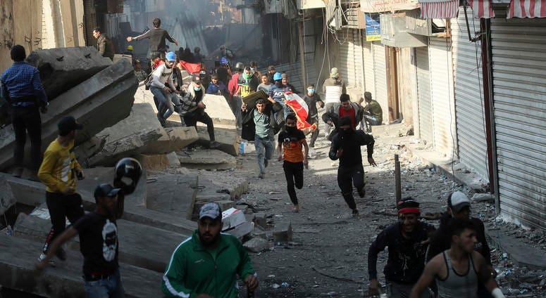 Security forces try to disperse anti-government protesters during clashes in Baghdad, Iraq, Saturday, Nov. 30, 2019. Security forces try to disperse anti-government protesters during clashes in Baghdad, Iraq, Saturday, Nov. 30, 2019.