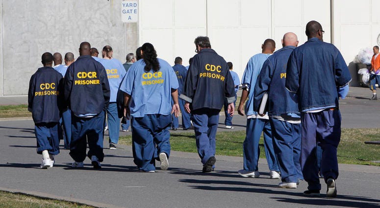 Inmates walk through the exercise yard at California State Prison Sacramento, near Folsom, Calif., on Feb. 26, 2013. Inmates walk through the exercise yard at California State Prison Sacramento, near Folsom, Calif., on Feb. 26, 2013.