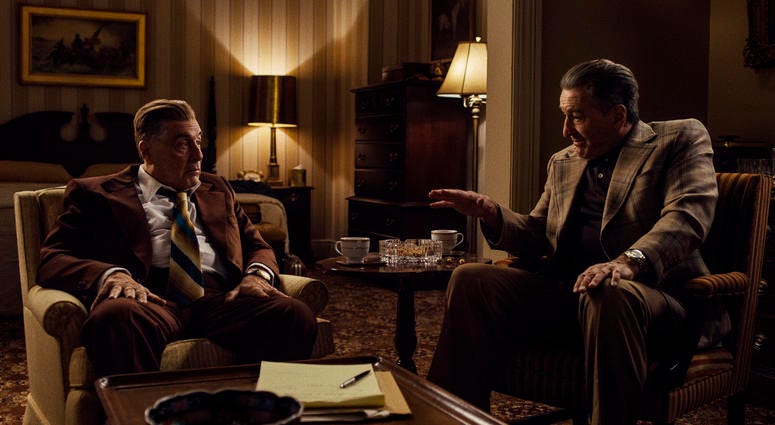This image released by Netflix shows Al Pacino portraying Jimmy Hoffa, left, and Robert De Niro as Frank Sheeran in a scene from "The Irishman." The New York Film Critics Circle named “The Irishman” the year's best film. The Irishman