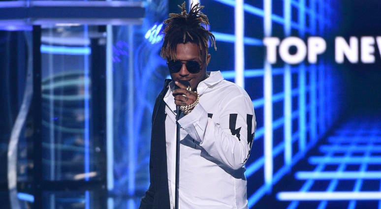 In this May 1, 2019 file photo, Juice WRLD accepts the award for top new artist at the Billboard Music Awards at the MGM Grand Garden Arena in Las Vegas. Juice WRLD
