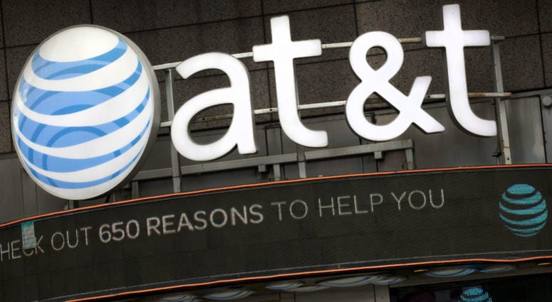 In this Monday, Oct. 24, 2016, file photo, the AT&T logo is positioned above one of its retail stores, in New York. In this Monday, Oct. 24, 2016, file photo, the AT&T logo is positioned above one of its retail stores, in New York.