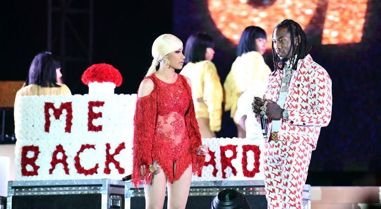 Singer Cardi B (L) is presented a 'Take Me Back' card onstage by her husband Offset (R) during day 2 of the Rolling Loud Festival at Banc of California Stadium on December 15, 2018 in Los Angeles, California.