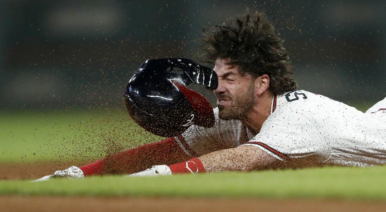 Atlanta Braves' Dansby Swanson slides into second base with a double during the seventh inning of the team's baseball game against the Philadelphia Phillies on Thursday, Sept. 20, 2018, in Atlanta. Atlanta Braves' Dansby Swanson slides into second base with a double during the seventh inning of the team's baseball game against the Philadelphia Phillies on Thursday, Sept. 20, 2018, in Atlanta.