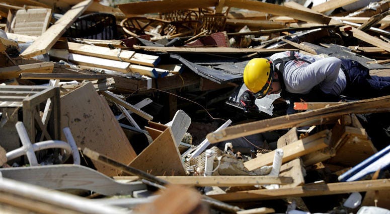 A member of a South Florida urban search and rescue team sifts through a debris pile for survivors of hurricane Michael in Mexico Beach, Fla., Sunday, Oct. 14, 2018. A member of a South Florida urban search and rescue team sifts through a debris pile for survivors of hurricane Michael in Mexico Beach, Fla., Sunday, Oct. 14, 2018.
