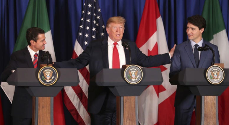 President Donald Trump, center, reaches out to Mexico's President Enrique Pena Nieto, left, and Canada's Prime Minister Justin Trudeau as they prepare to sign a new United States-Mexico-Canada Agreement that is replacing the NAFTA trade deal. President Donald Trump, center, reaches out to Mexico's President Enrique Pena Nieto, left, and Canada's Prime Minister Justin Trudeau as they prepare to sign a new United States-Mexico-Canada Agreement that is replacing the NAFTA trade deal.