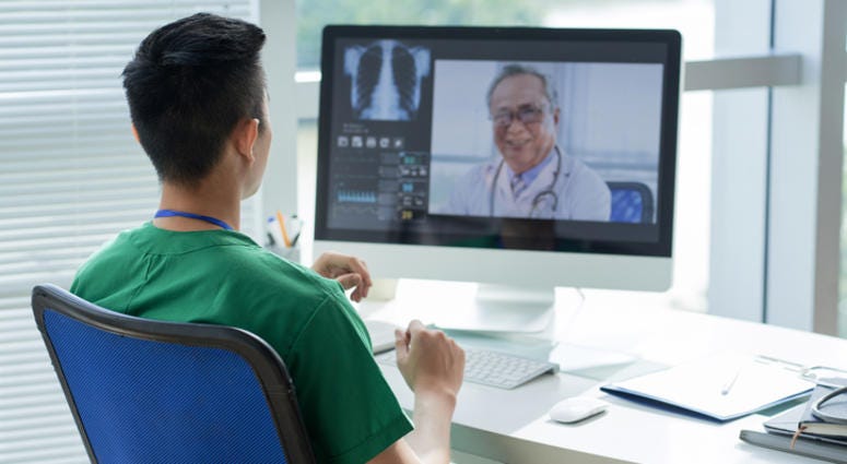 Two doctors communicating through a computer. Two doctors communicating through a computer.