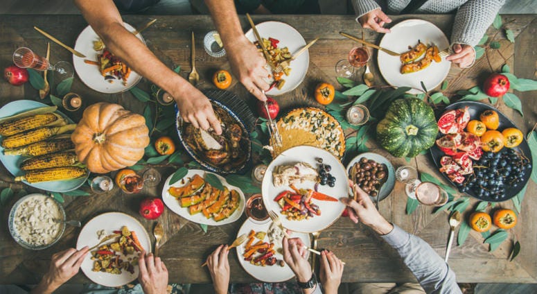 People eating a holiday table. People eating a holiday table.