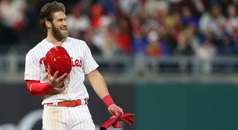 Bryce Harper, #3 of the Philadelphia Phillies, smiles after advancing to second base on a ball off the bat of J.T. Realmuto that was misplayed by third baseman J.D. Davis of the New York Mets, Citizens Bank Park on April 16, 2019. Bryce Harper