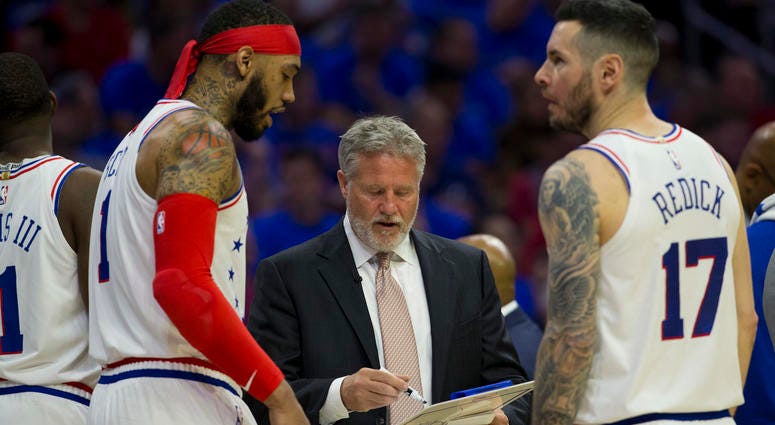 Head coach Brett Brown of the Philadelphia 76ers talks to Mike Scott and JJ Redick against the Toronto Raptors in Game Three of the Eastern Conference Semifinals at the Wells Fargo Center on May 2, 2019 in Philadelphia, Pennsylvania. Brett Brown talks to Mike Scott and JJ Redick during Game Three.