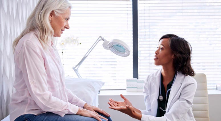 A woman talking to her doctor. A woman talking to her doctor.