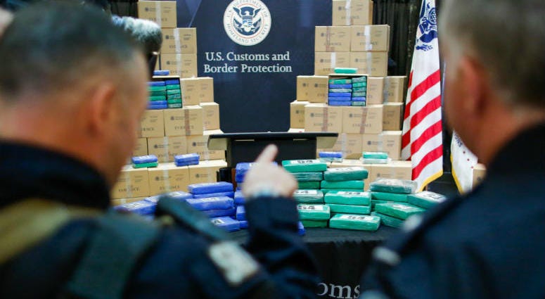 PHILADELPHIA, PA - JUNE 21: Police officers stand guard near cocaine seized from a cargo ship at a Philadelphia port, during a news conference at the U.S. Custom House on June 21, 2019 in Philadelphia, Pennsylvania. At least 17.5 tons of cocaine with more than $1 billion in street value was seized at the Philadelphia seaport, being the largest cocaine seizure in the 230-year history of U.S Customs and Border protection.