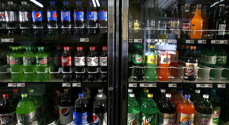 Various bottles of soda are displayed in a cooler at Marina Supermarket on July 22, 2014 in San Francisco, California. Various bottles of soda are displayed in a cooler.