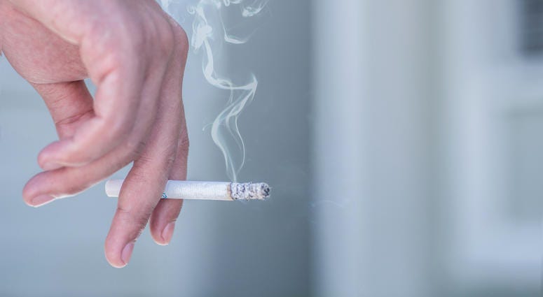 man smoking a cigarette - stock photo man smoking a cigarette - stock photo