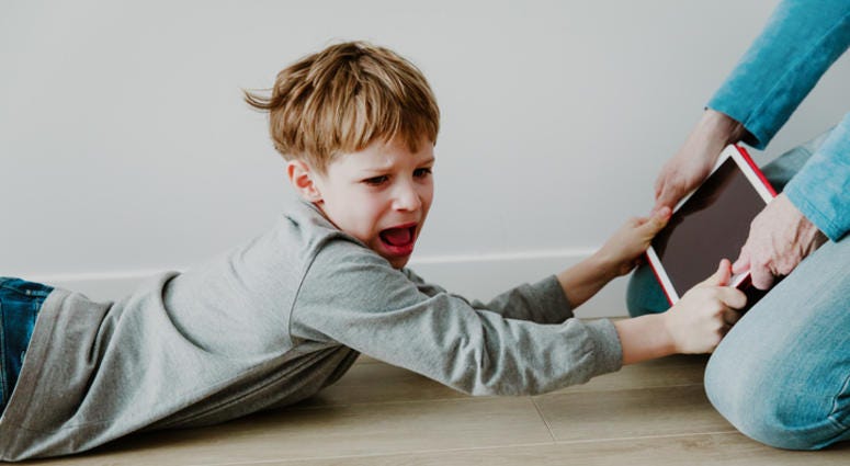 father taking touch pad from angry child. screen time