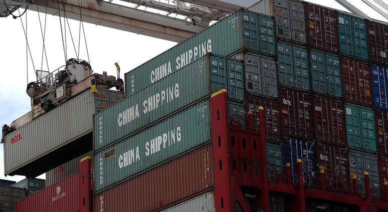 A shipping container is offloaded from the Hong Kong based CSCL East China Sea container ship at the Port of Oakland on June 20, 2018 in Oakland, California. A shipping container