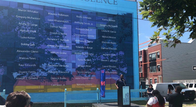 Councilman Kenyatta Johnson at the anti-violence mural that struck community controversy a year ago when a developer mistakenly destroyed that has been officially restored and was dedicated Wednesday. The anti-violence mural that struck community controversy a year ago when a developer mistakenly destroyed it has been officially restored and was dedicated Wednesday.