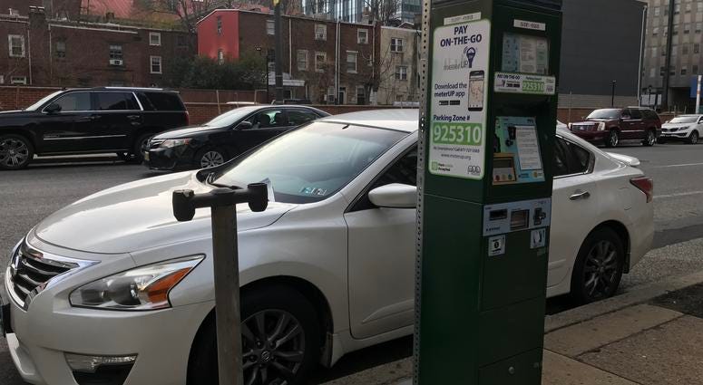 A Center City parking kiosk next to the remains of an old meter stand. A Center City parking kiosk next to the remains of an old meter stand.