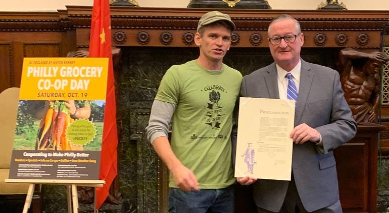 Jon Roesser, general manager of Weaver’s Way co-op, with Mayor Jim Kenney, at the Co-op Day proclamation ceremony. Jon Roesser, general manager of Weaver’s Way co-op, with Mayor Jim Kenney