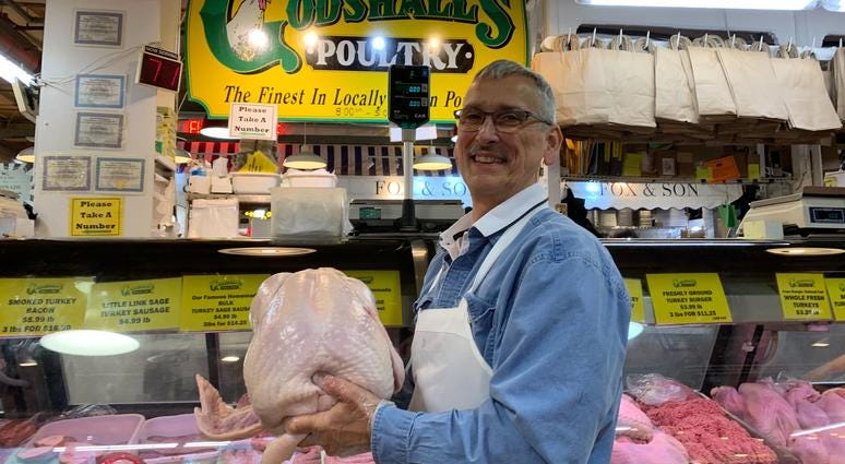 Dean Frankenfield of Godshall's Poultry in Reading Terminal Market holds a 25-pound turkey. Dean Frankenfield in Reading Terminal Market with turkey