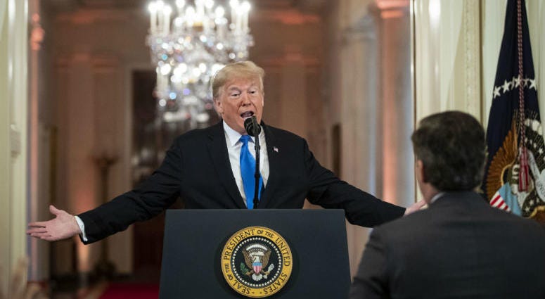 U.S. President Donald Trump gets into an exchange with CNN reporter Jim Acosta during a news conference a day after the midterm elections on November 7, 2018 in the East Room of the White House in Washington, DC.