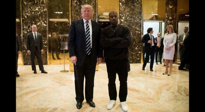 President-elect Donald Trump and Kanye West stand together in the lobby at Trump Tower, December 13, 2016 in New York City.