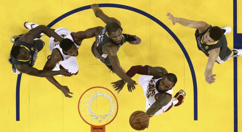 Cleveland Cavaliers forward LeBron James, bottom, shoots against the Golden State Warriors during the second half of Game 2 of basketball's NBA Finals in Oakland, Calif., Sunday, June 3, 2018. Cleveland Cavaliers forward LeBron James, bottom, shoots against the Golden State Warriors during the second half of Game 2 of basketball's NBA Finals in Oakland, Calif., Sunday, June 3, 2018.