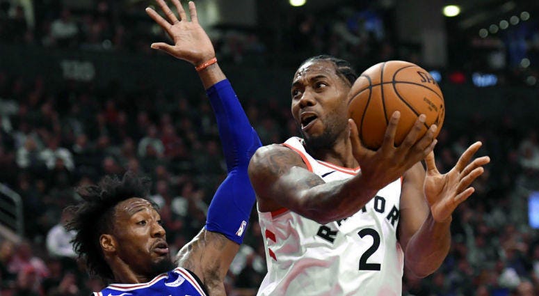 Toronto Raptors forward Kawhi Leonard (2) is fouled by Philadelphia 76ers forward Robert Covington (33) during the first half of an NBA basketball game, Tuesday, Oct. 30, 2018 in Toronto.