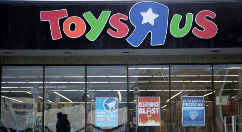 This Jan. 24, 2018, file photo shows a person walking near the entrance to a Toys R Us store, in Wayne, N.J. This Jan. 24, 2018, file photo shows a person walking near the entrance to a Toys R Us store, in Wayne, N.J.