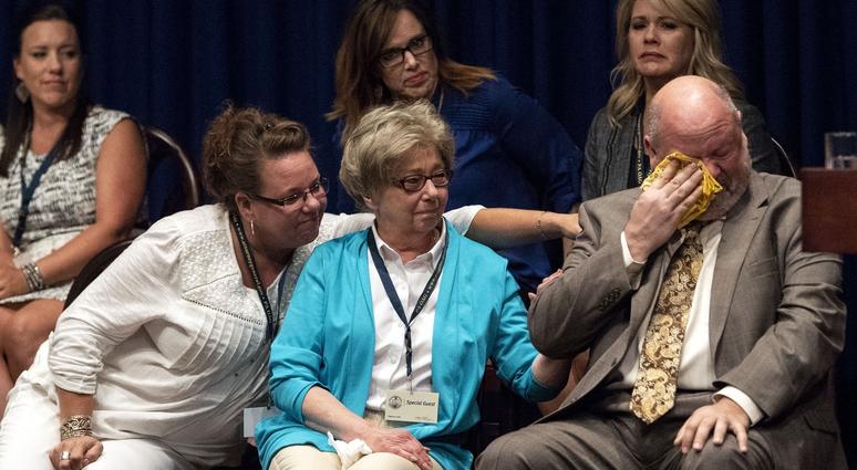 James Faluszczuk, right, who was abused in the Erie diocese, cries as Attorney General Josh Shapiro outlined the findings of the grand jury investigation into six catholic diocese in Pennsylvania, Aug. 14, 2018. Child sex abuse victims