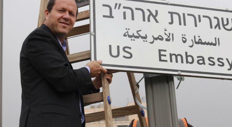 In this photo released by the Jerusalem Municipality, In this photo released by the Jerusalem Municipality, Jerusalem mayor Nir Barkat poses with a new road sign to the new U.S. Embassy in Jerusalem, Monday, May 7, 2018., Monday, May 7, 2018. Jerusalem Mayor Nir Barkat poses with a new road sign to the new U.S. Embassy in Jerusalem