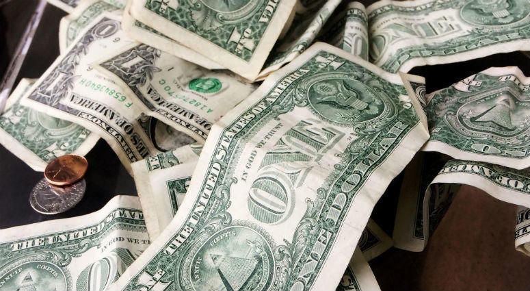 This Sept. 6, 2017, file photo, shows currency from a tip jar in New York. U.S. currency