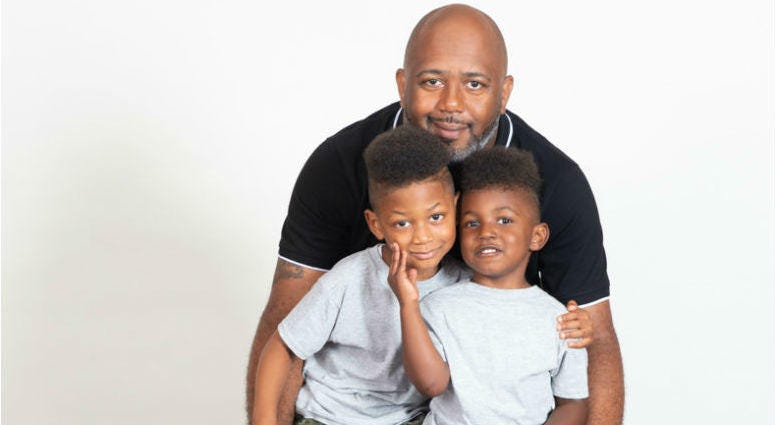 Eric Johnson and his two foster children, Edward and Sencere. Eric Johnson