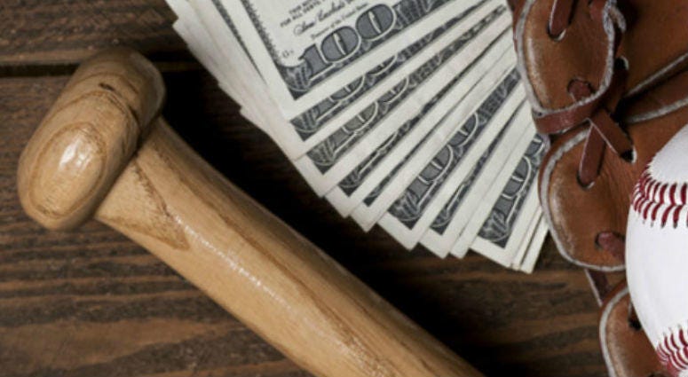 Photo of an Baseball ball, glove, bat and money on wooden table. Studio shot Baseball Money Generic