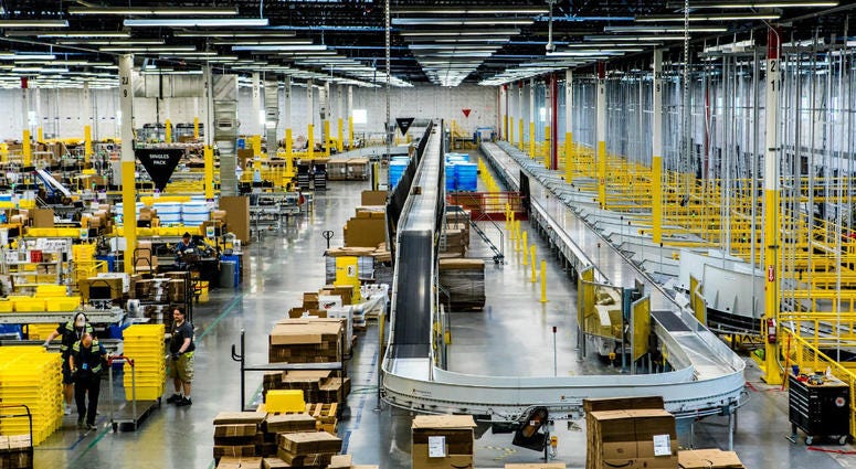 Inside an Amazon fulfillment center, a conveyer belt is used to organize packages. Amazon Fulfillment Center