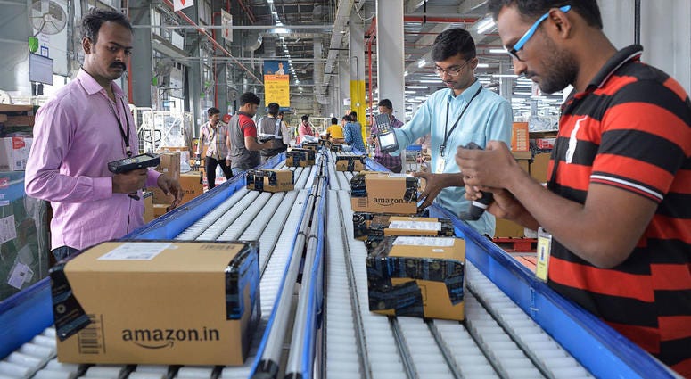 Employees of Amazon India scan packages at a new fulfilment centre on the outskirts of Bangalore. Amazon and Walmart face new rules in India that could prevent them from using their industry expertise and massive size to drive down prices. Amazon and Walmart want to transform e-commerce in India