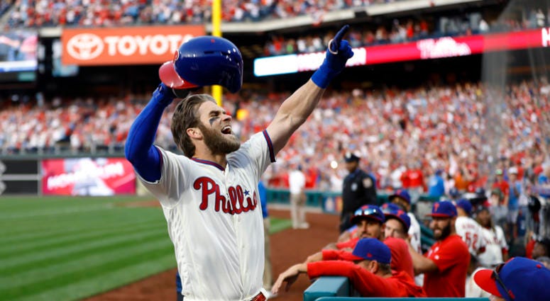 Philadelphia Phillies' Bryce Harper celebrates after hitting a home run off Atlanta Braves relief pitcher Jesse Biddle during the seventh inning of a baseball game, Saturday, March 30, 2019, in Philadelphia. Philadelphia Phillies' Bryce Harper celebrates after hitting a home run off Atlanta Braves relief pitcher Jesse Biddle during the seventh inning of a baseball game, Saturday, March 30, 2019, in Philadelphia.