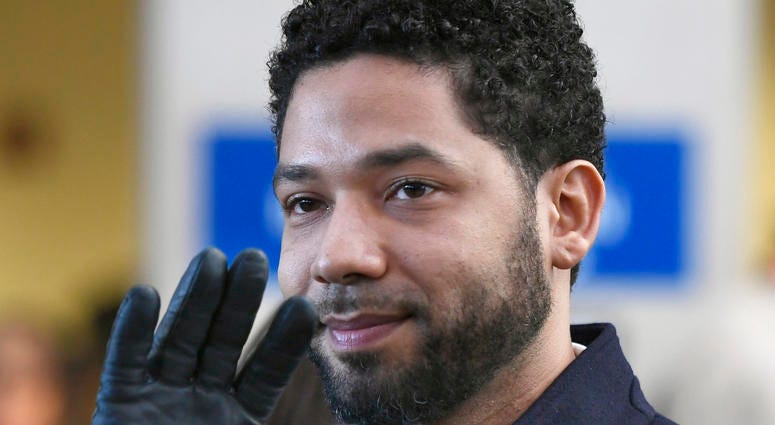 FILE - In this March 26, 2019, file photo, actor Jussie Smollett smiles and waves to supporters before leaving Cook County Court after his charges were dropped in Chicago. A deadline is looming for Smollett to pay over $130,000 to Chicago to cover part of FILE - In this March 26, 2019, file photo, actor Jussie Smollett smiles and waves to supporters before leaving Cook County Court after his charges were dropped in Chicago. A deadline is looming for Smollett to pay over $130,000 to Chicago to cover part of