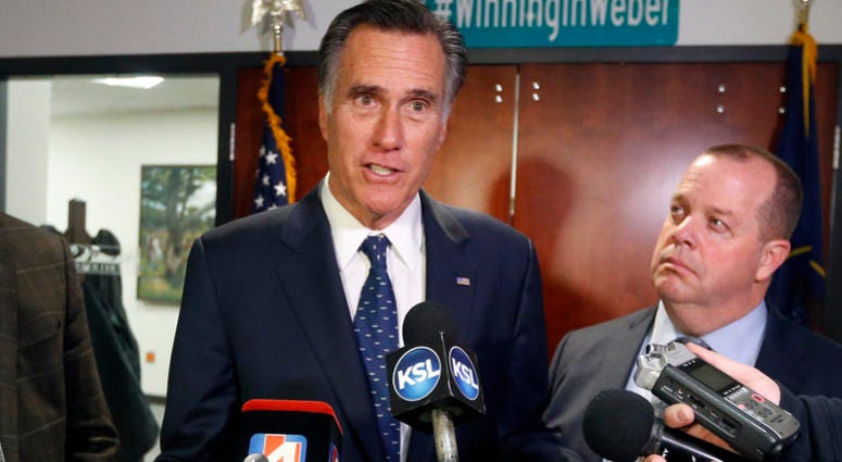 FILE - In this Friday Jan., 18, 2019 file photo, Utah Sen. Mitt Romney, left, speaks with reporters after visiting with local officials to discuss how the four-week partial government shutdown is impacting an area with several major federal employers, in FILE - In this Friday Jan., 18, 2019 file photo, Utah Sen. Mitt Romney, left, speaks with reporters after visiting with local officials to discuss how the four-week partial government shutdown is impacting an area with several major federal employers, in