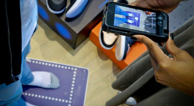 Nike officials demonstrate the company's foot-scanning tool on its app that will measure and remember the length, width and other dimensions of customers' feet after they point a smartphone camera to their toes, Wednesday April 24, 2019, in New York. Nike officials demonstrate the company's foot-scanning tool on its app that will measure and remember the length, width and other dimensions of customers' feet after they point a smartphone camera to their toes, Wednesday April 24, 2019, in New York.
