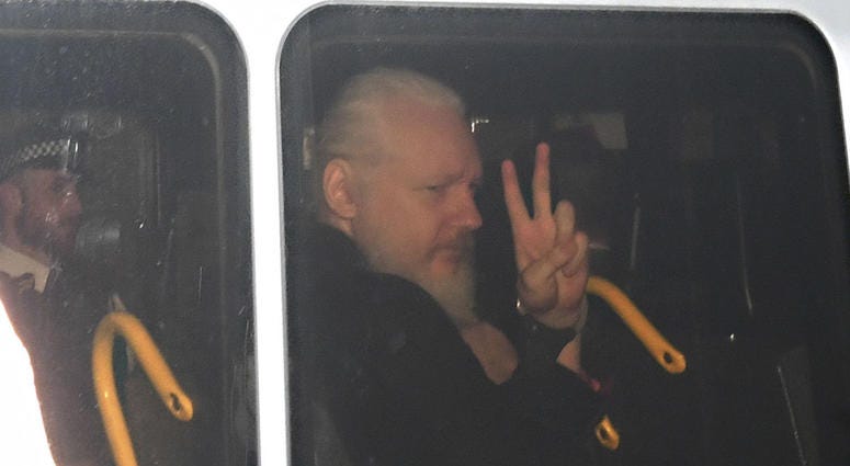 Julian Assange signals his arrival at the Court of Magistrates of Westminster, in London, after agents removed him from the Ecuadorian embassy and arrested him, on Thursday, April 11, 2019. Julian Assange signals his arrival at the Court of Magistrates of Westminster, in London, after agents removed him from the Ecuadorian embassy and arrested him, on Thursday, April 11, 2019.